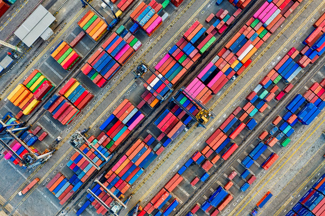 services-03 Aerial view of vibrant shipping containers at a busy Jakarta port, showcasing global trade.